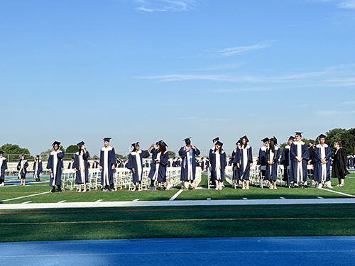 High school graduates lined up on the track during ceremony