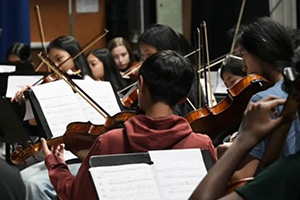 back of students playing instruments