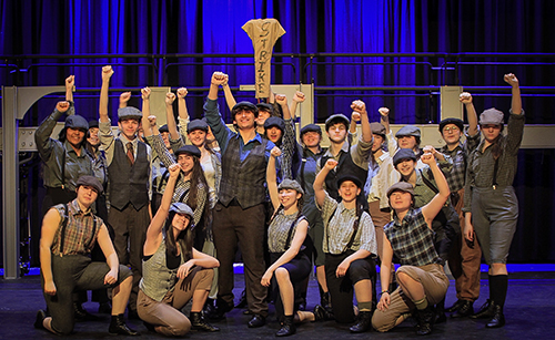 Cast of  Newsies on the stage