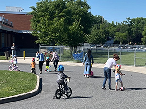 Kids driving trikes on road