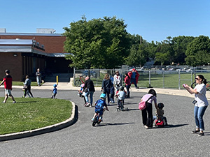 Kids and adults taking trikes on road